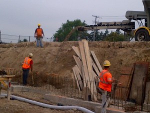 Stone being placed around window wells